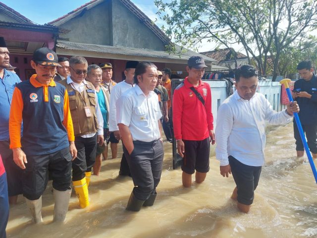 Pj Gubernur Banten Al Muktabar didampingi Kepala BPBD Provinsi Banten Nana Suryana meninjau lokasi banjir di Teluknaga, Kabupaten Tangerang.